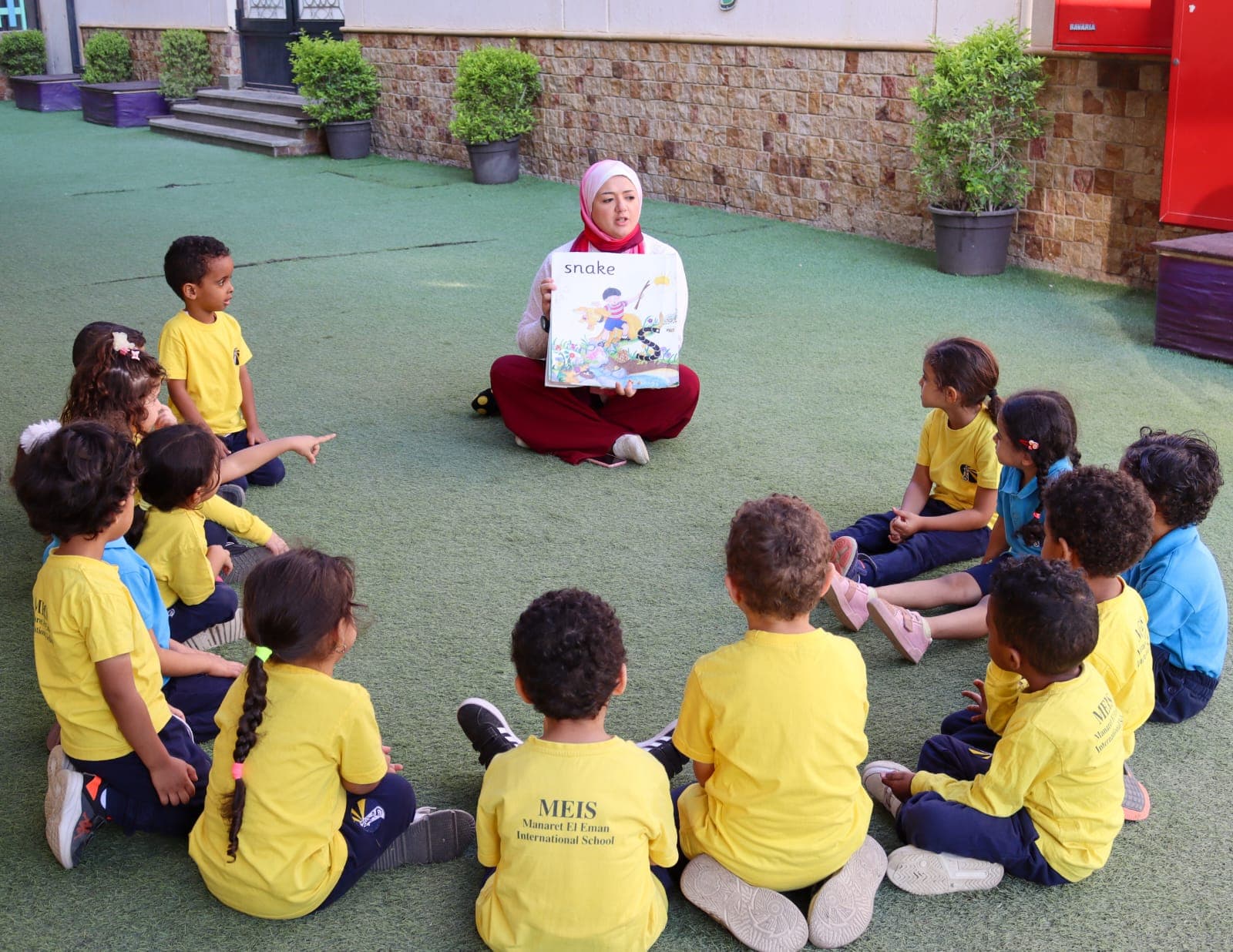 Young students listening to a story outdoors
