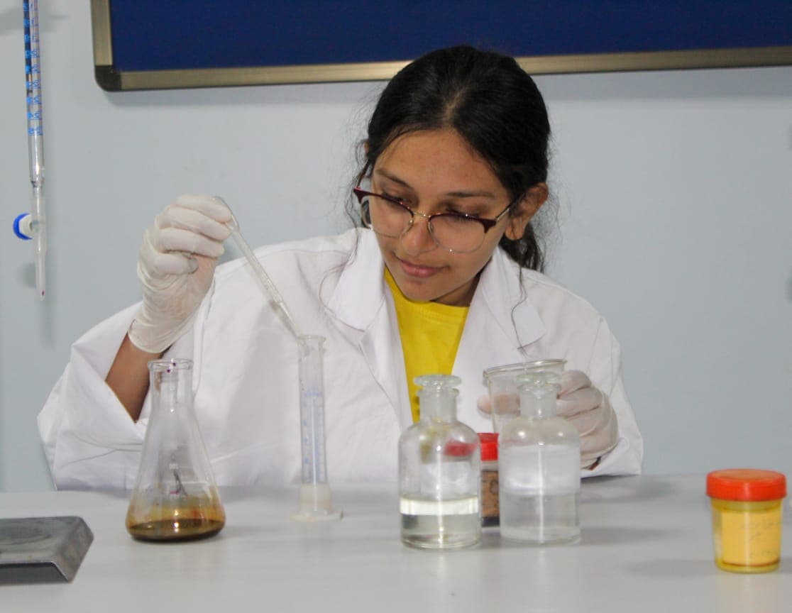 A student measuring liquids in the lab