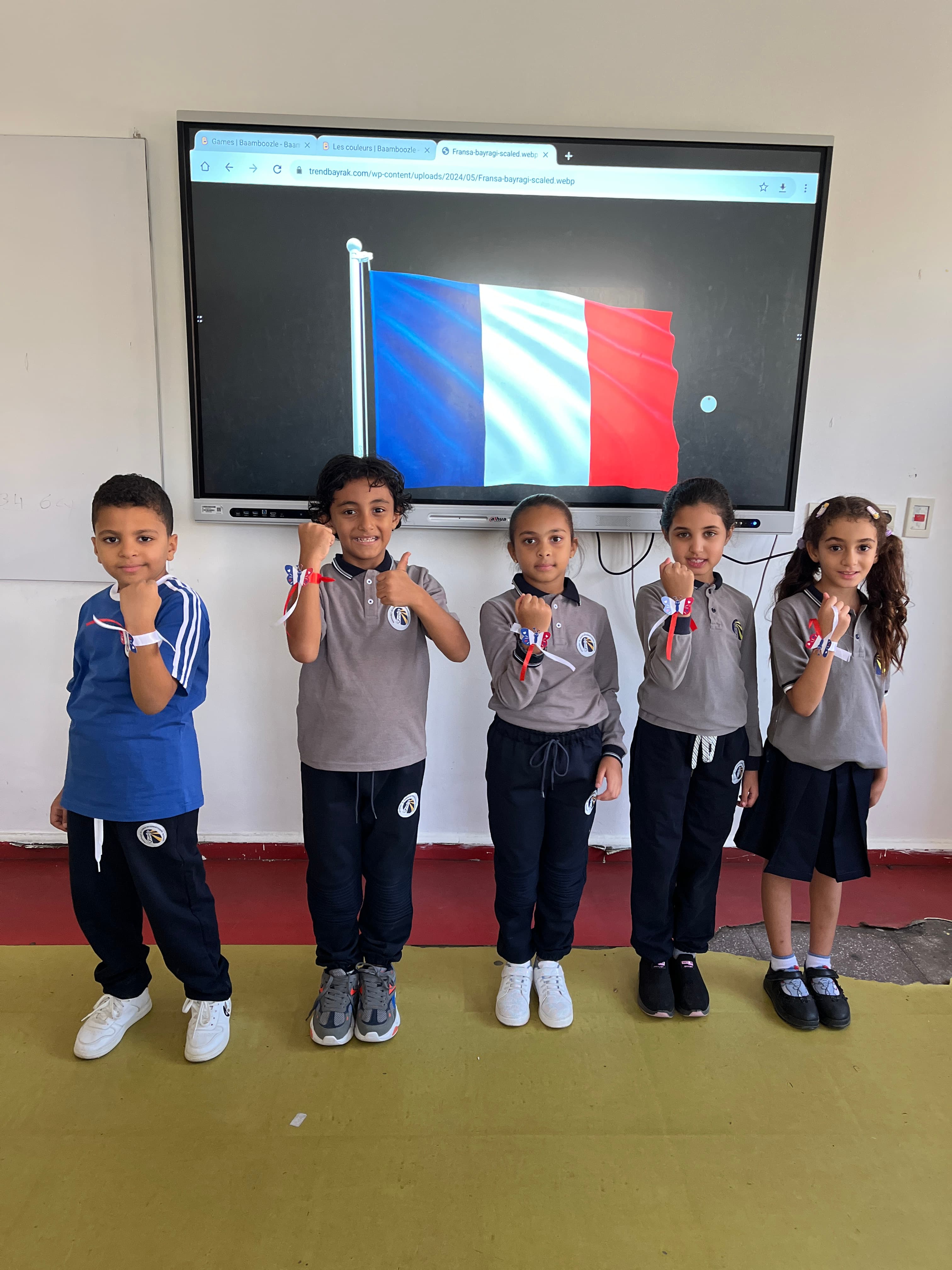 Students with a classroom screen