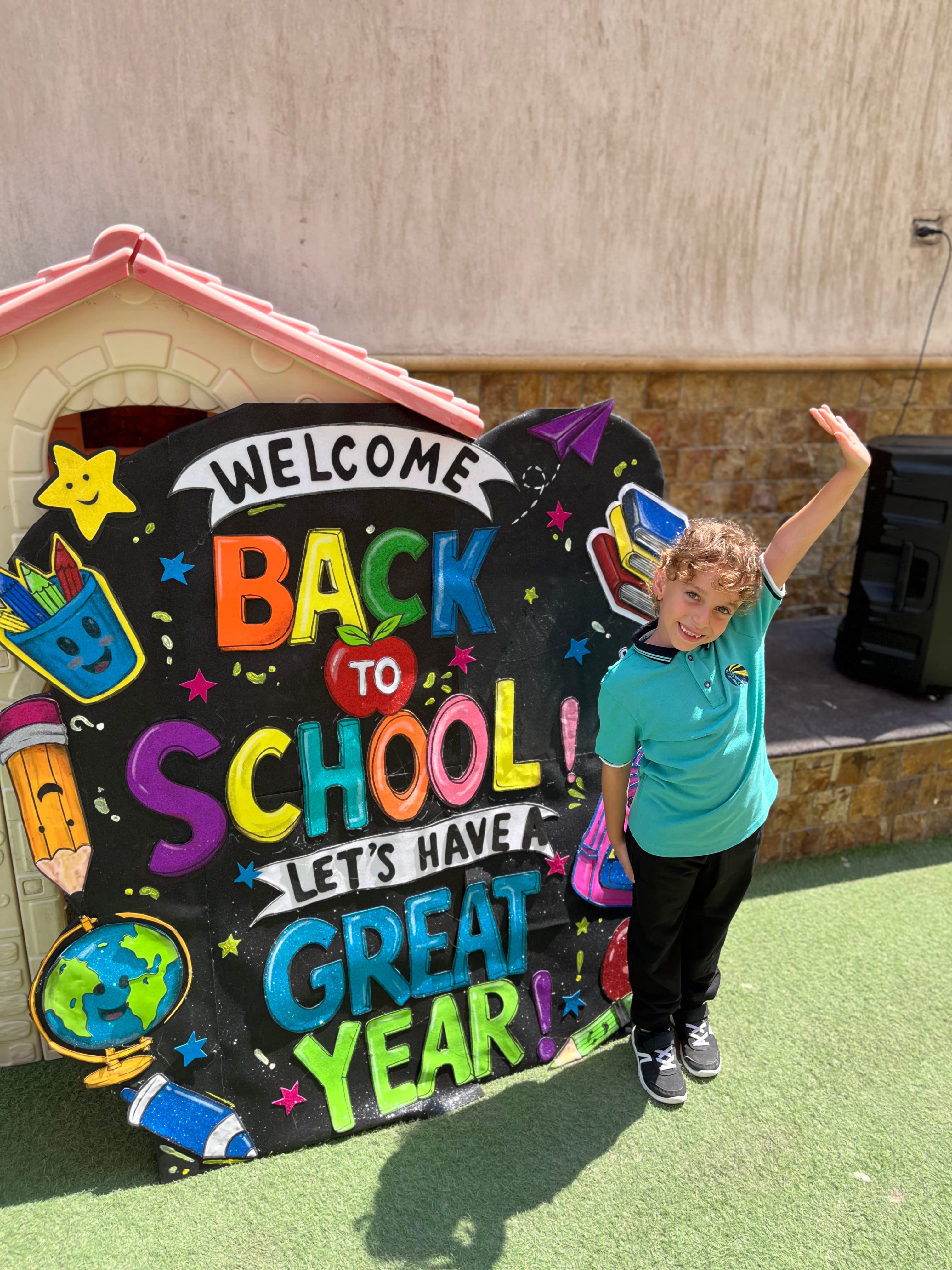 A student with a “Back to School” board