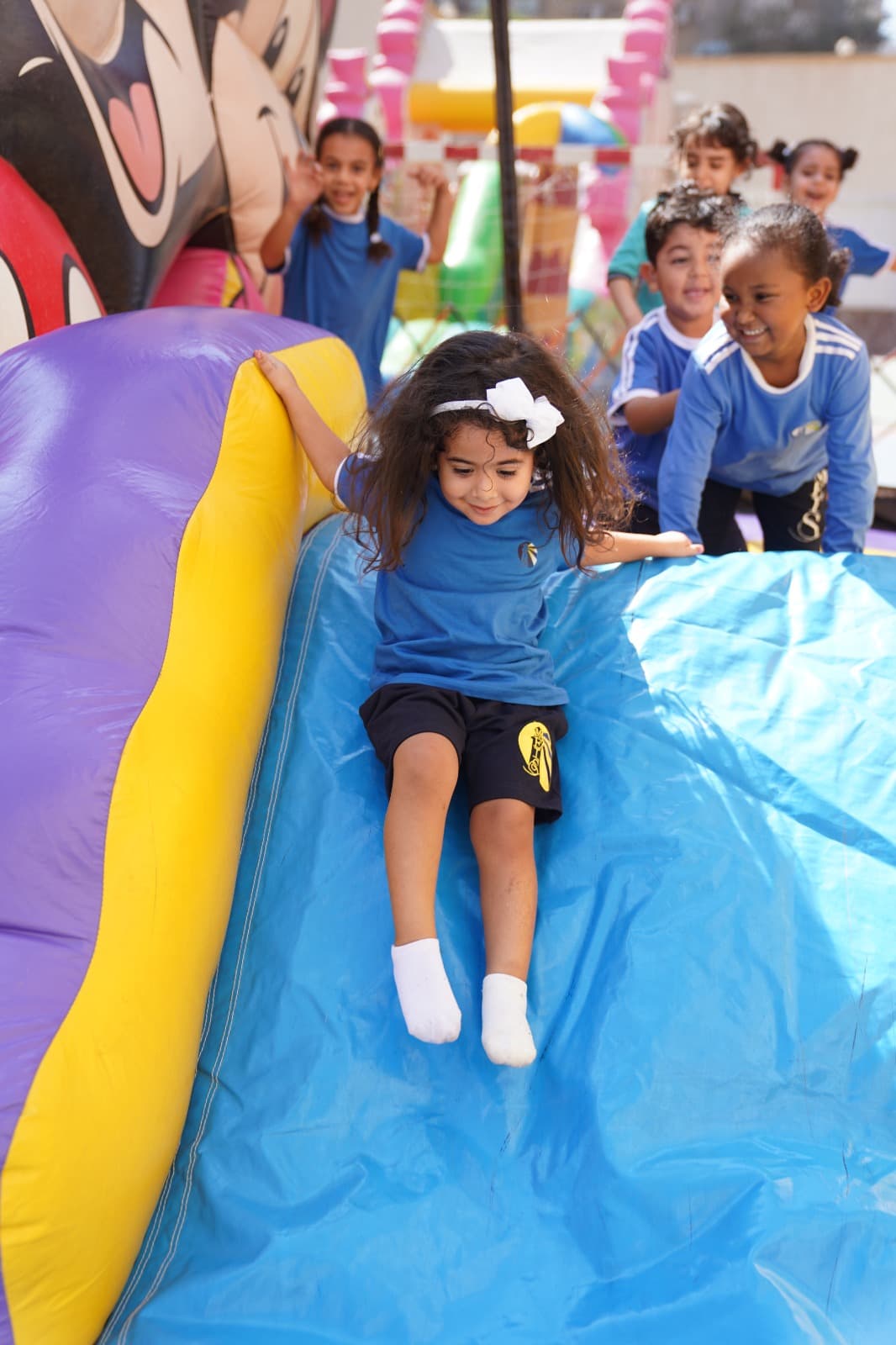 Young students on the slide at a fun day